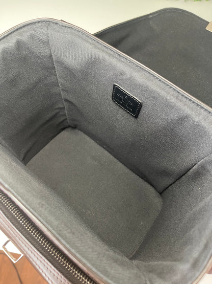 Interior of brown handbag with dark cloth interior 