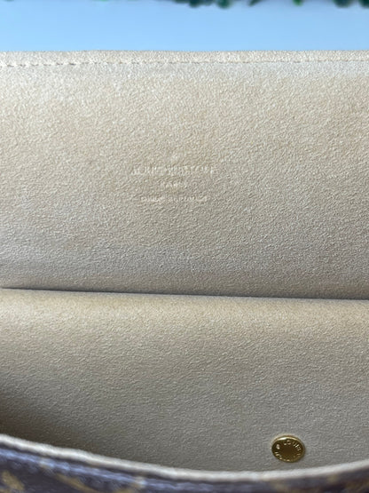 Heat stamp within the tan suede interior of a preowned Louis Vuitton Monogram Beverly GM handbag.