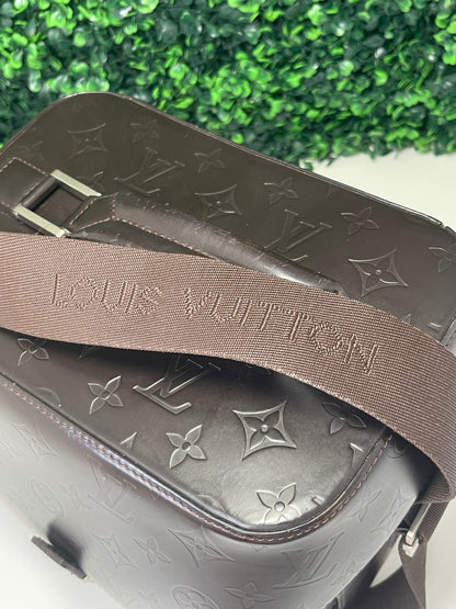 View is of brown handbag on the top handle and strap 