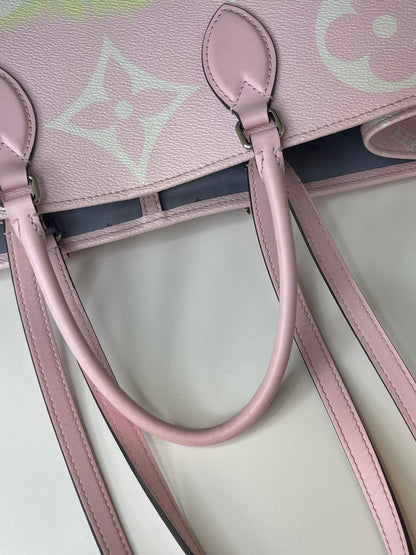 Pink leather handle and should straps on pink Pink Louis Vuitton OnTheGo Escale handbag GM.   