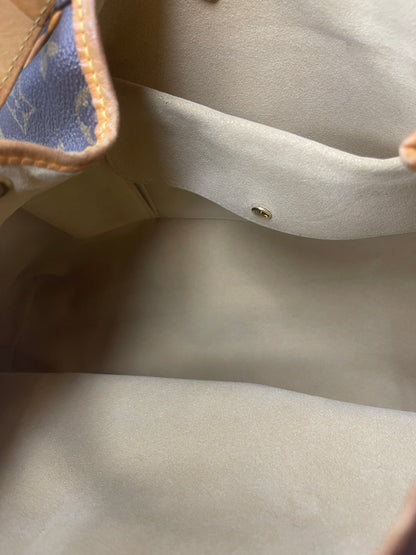 Tan cloth interior of a monogram Preowned Louis Vuitton Galliera PM with a slip pocket.