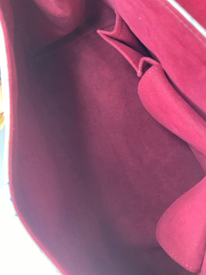 Red suede interior of a white Preowned Louis Vuitton Multicolor Beverly GM handbag.