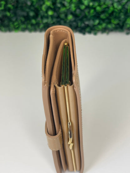 Top view of a preowned Louis Vuitton tan vernis leather wallet with a monogram pattern and a tan leather interior, featuring a lock and key mechanism.