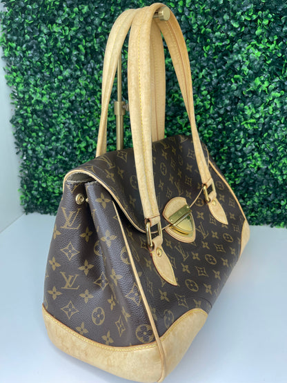 The side view of a preowned Louis Vuitton Monogram Beverly GM handbag with a brown and beige color scheme, featuring the brand's iconic LV logo, tan leather trim, displayed against a green-tone background.
