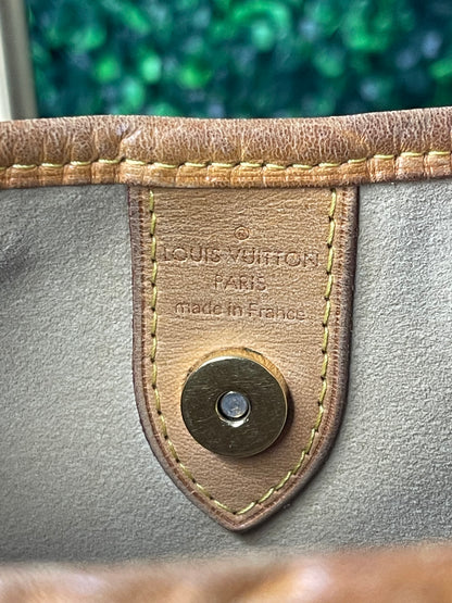 Leather interior LV heat stamp of a brown monogram Preowned Louis Vuitton Galliera PM.