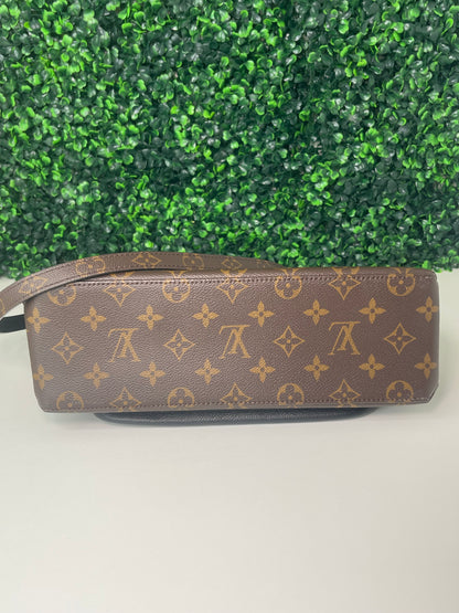 Bottom view of preowned Louis Vuitton Marignan handbag with brown and tan monogram canvas. 