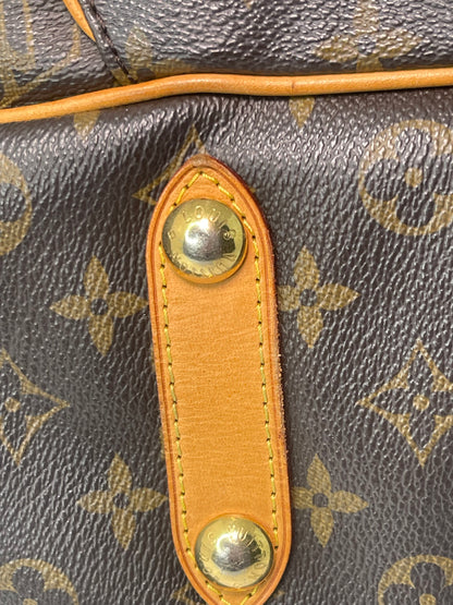 Zoomed in image of bottom gold hardware on a monogram Preowned Louis Vuitton Galliera PM.