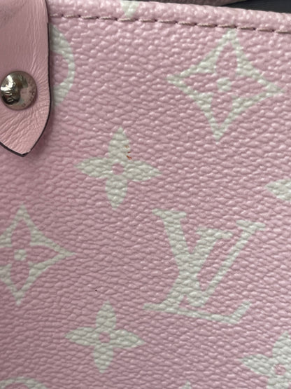 Pink exterior canvas zoomed in on Louis Vuitton OnTheGo Escale handbag GM.  