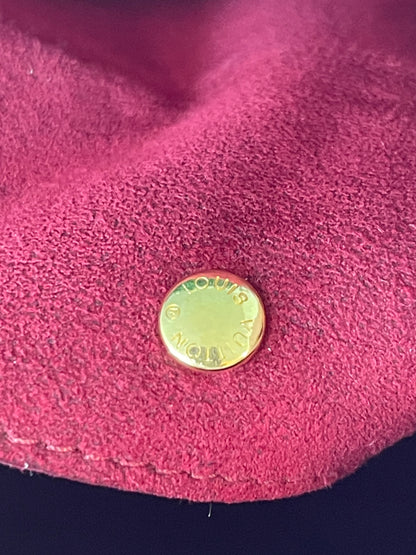 Gold button snap on red suede interior of a white Preowned Louis Vuitton Multicolor Beverly GM handbag.