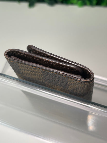 Side edge view of a preowned Louis Vuitton Damier Ebene Multicles 4 Key Holder.