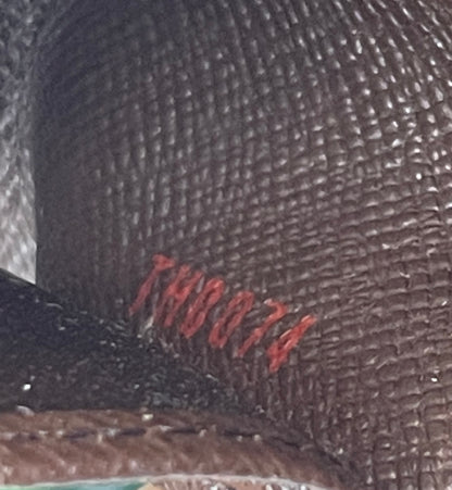 Zoomed in image of LV date code on interior pocket of a preowned Louis Vuitton Damier Ebene Multicles 4 Key Holder. 