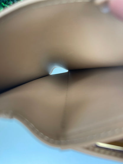 Interior view of slip pocket of a preowned Louis Vuitton tan vernis leather wallet and a tan leather interior. 