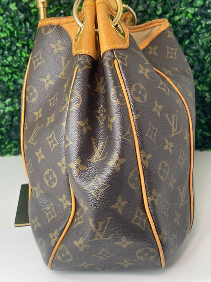 Side view of a brown monogram Preowned Louis Vuitton Galliera PM.