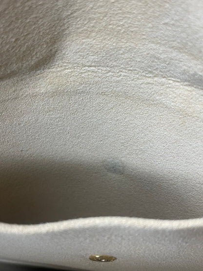 Tan cloth interior slip pocket of a monogram Preowned Louis Vuitton Galliera PM.