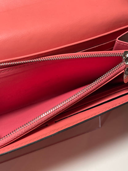 Top view of interior coin pouch and zipper with silver hardware of a pink glossy preowned Louis Vuitton long wallet with vernis leather.