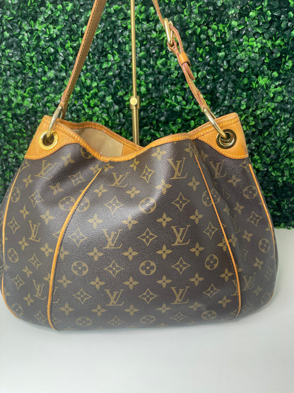 Back side view of a brown monogram Preowned Louis Vuitton Galliera PM with gold hardware.