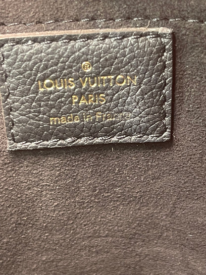 Black leather Heat stamp inside of a preowned Louis Vuitton Marignan handbag. 