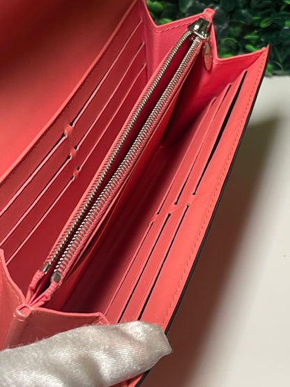 Interior view with several card slots and zipper coin pouch of preowned Louis Vuitton long wallet.