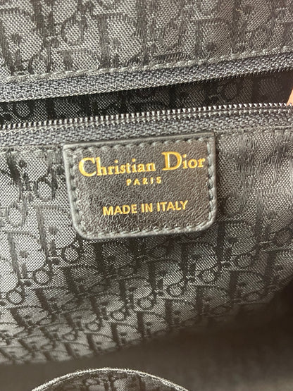 Leather heat stamp reading Christian Dior on the interior pocket of the Preowned Dior black leather handbag.